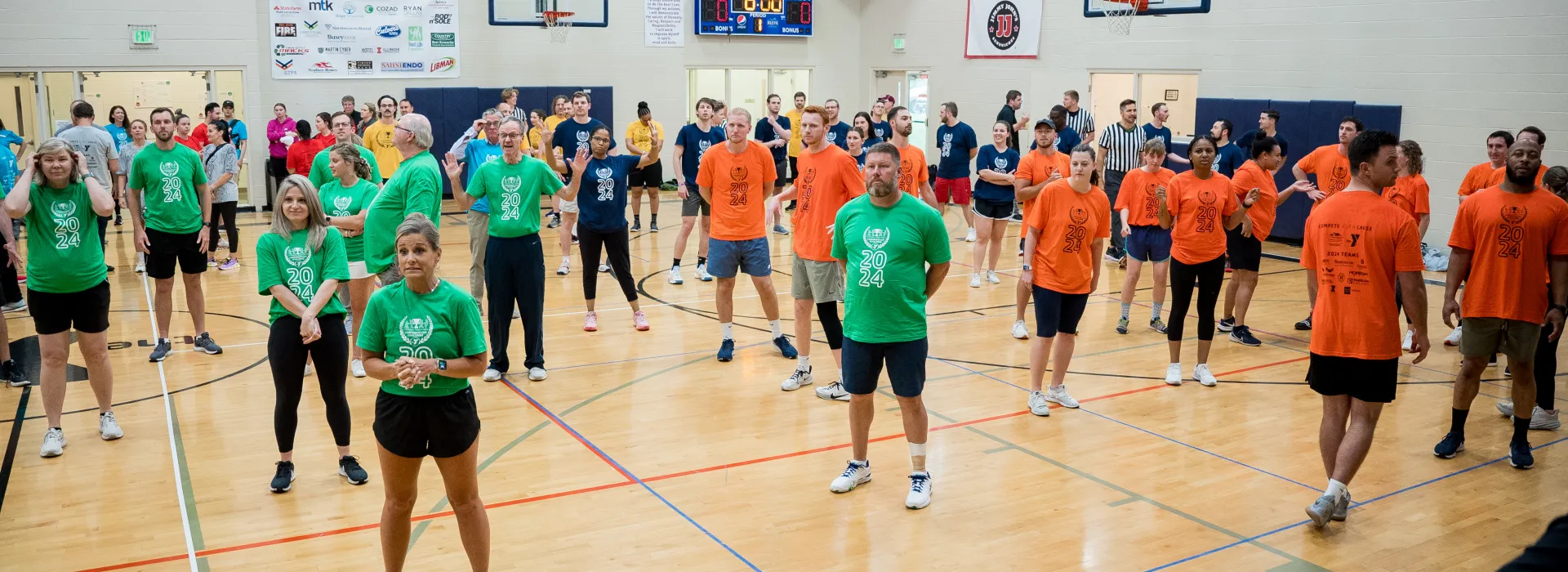 Gym full of teams wearing colorful shirts
